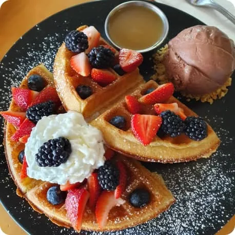 Waffles with berries, cream and ice cream served at Jolly Coffee