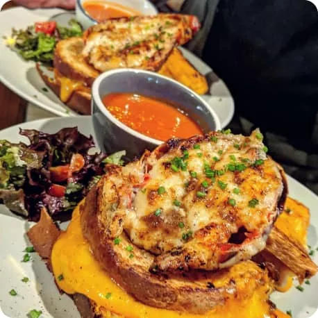 Lobster toasts with salad and sauce